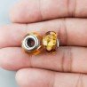 Perlina foro largo dorato con macchie bionde 13.5x8.5mm 1pz