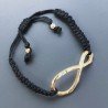Bracciale Intrecciato con Centrale in Ottone Dorato a Forma Infinito e Chiusura Sali e Scendi