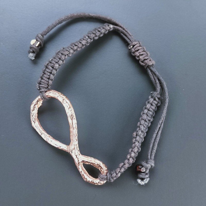 Bracciale Intrecciato con Centrale in Ottone Rosato a Forma Infinito e Chiusura Sali e Scendi