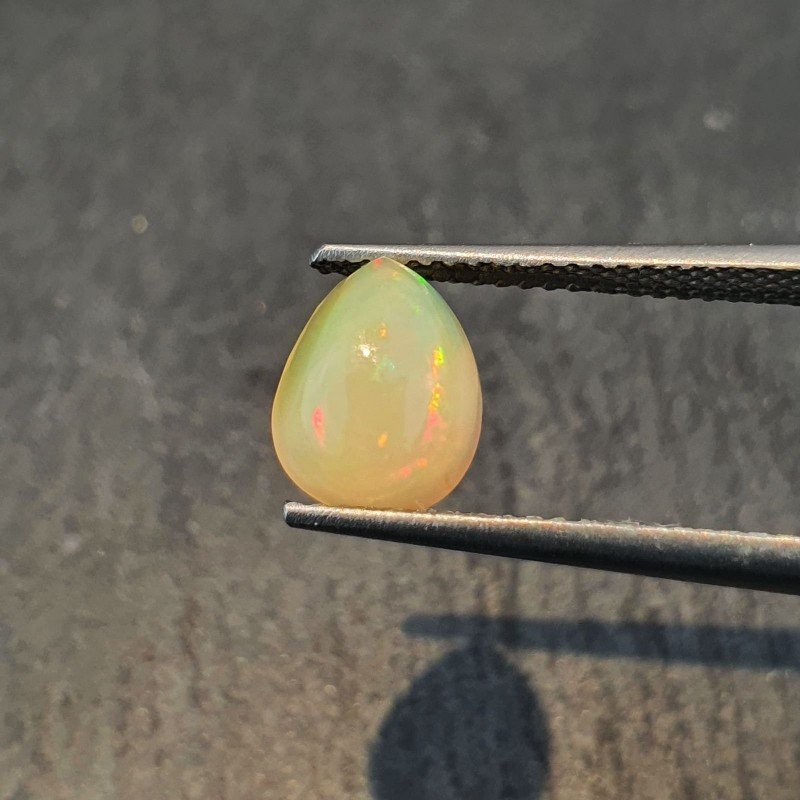 Opale Etiope 'Welo' Naturale Forma Goccia Piatto Cabochon Liscio Fatto a Mano 7x9x4mm 1,20 Carati 1pz