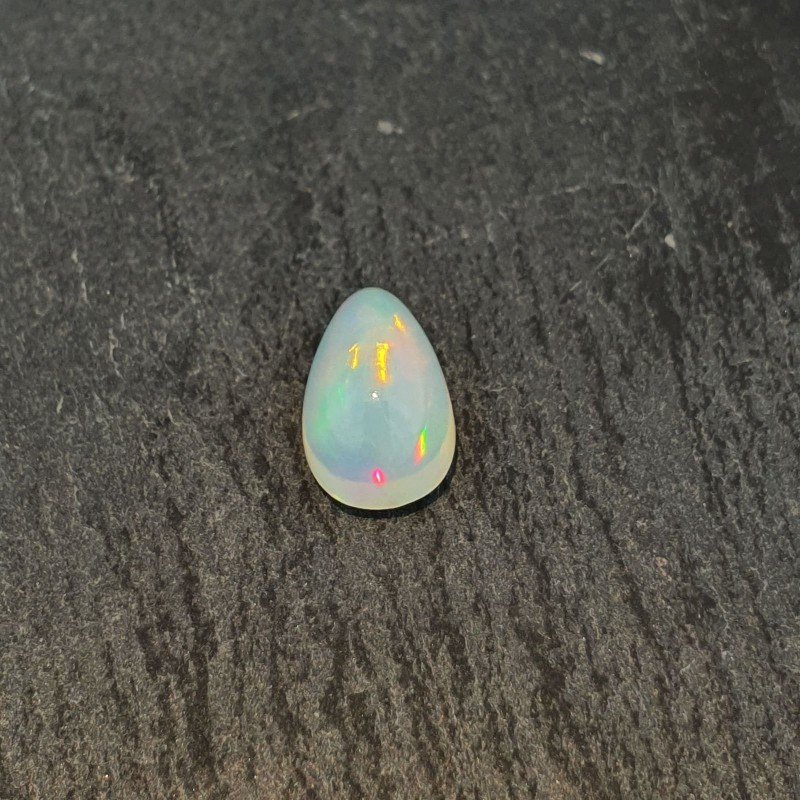 Opale Etiope 'Welo' Naturale Forma Goccia Piatto Cabochon Liscio Fatto a Mano 10x6x5mm 1,55 Carati 1pz