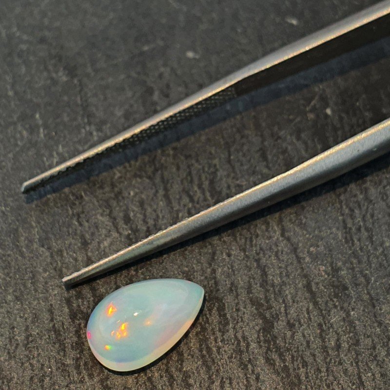 Opale Etiope 'Welo' Naturale Forma Goccia Piatto Cabochon Liscio Fatto a Mano 10x6x5mm 1,55 Carati 1pz