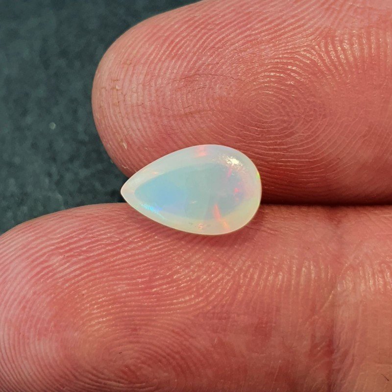Opale Etiope 'Welo' Naturale Forma Goccia Piatto Cabochon Liscio Fatto a Mano 10x6x5mm 1,55 Carati 1pz