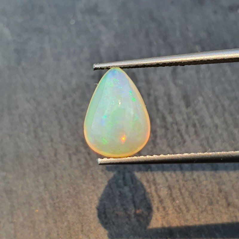 Opale Etiope 'Welo' Naturale Forma Goccia Piatto Cabochon Liscio Fatto a Mano 11x8x7mm 2,35 Carati 1pz