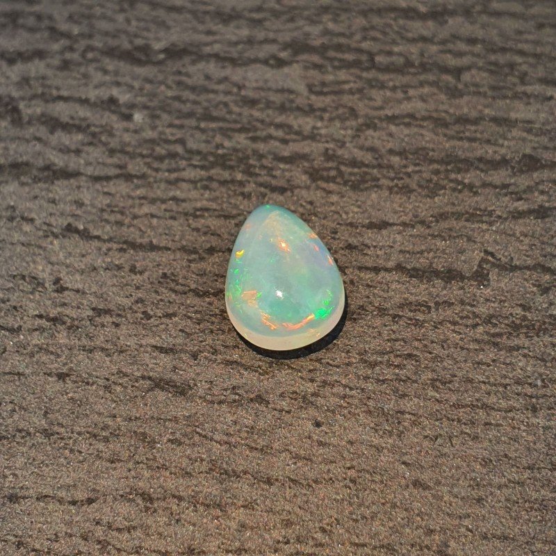 Opale Etiope 'Welo' Naturale Forma Goccia Piatto Cabochon Liscio Fatto a Mano 10x7x4mm 1,20 Carati 1pz