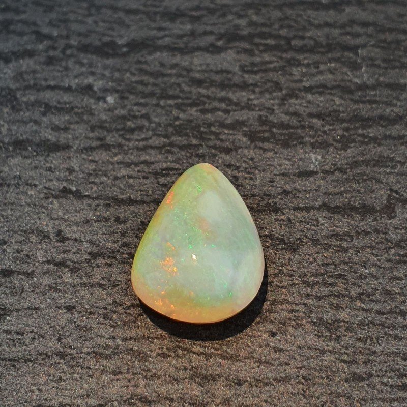 Opale Etiope 'Welo' Naturale Forma Goccia Piatto Cabochon Liscio Fatto a Mano 13X10X6,60mm 3,45 Carati 1pz