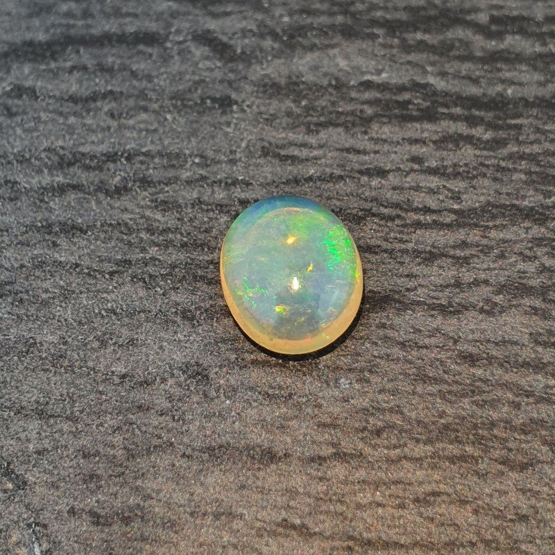 Opale Etiope 'Welo' Naturale Forma Ovale Piatto Cabochon Liscio Fatto a Mano 10X8X4mm 1.65 Carati 1pz